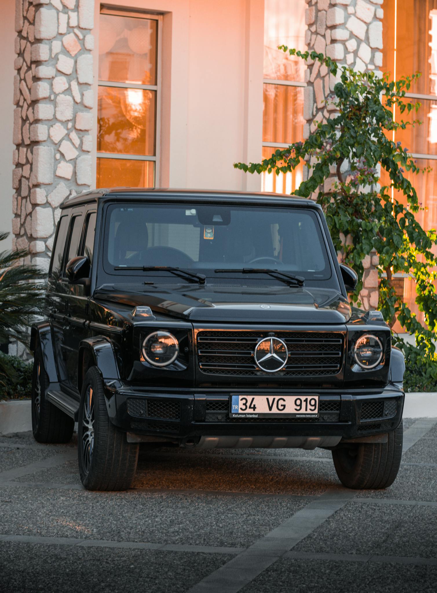 Front view of a luxury black Mercedes-Benz SUV parked outside a stylish building.
